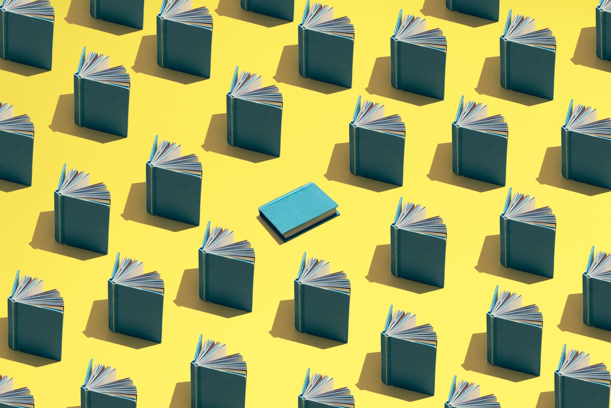 Blog featured image. An illustration of books propped open in rows against a yellow field and one blue book in center.
